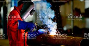 Man Welding a metal tube